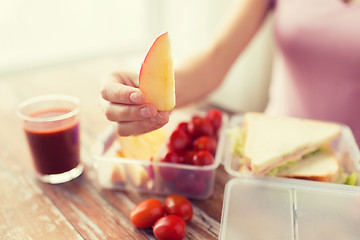 Image showing close up of woman with food in plastic container