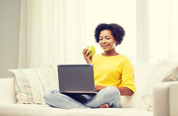 Image showing happy african american woman with laptop at home