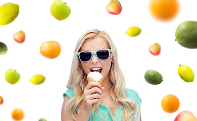 Image showing happy young woman in sunglasses eating ice cream