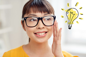 Image showing asian woman in glasses with light bulb doodle