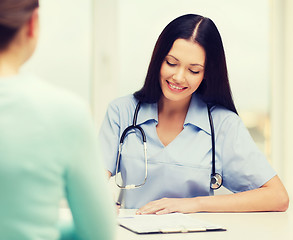 Image showing smiling doctor or nurse with patient