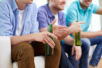 Image showing happy male friends with beer watching tv at home