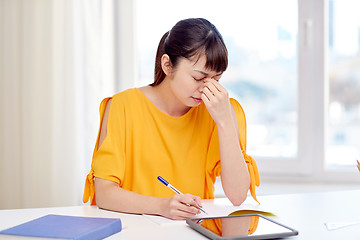 Image showing tired asian woman student with tablet pc at home
