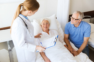 Image showing senior woman and doctor with clipboard at hospital