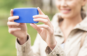 Image showing close up of woman taking picture with smartphone