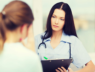 Image showing female doctor or nurse with patient