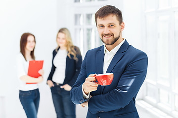 Image showing Young colleagues having coffee break in office