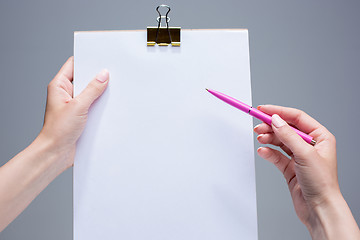 Image showing The notepad and pen in female hands
