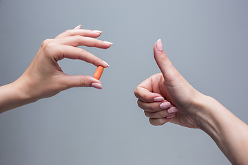 Image showing The female hands holding pill capsule closeup. 