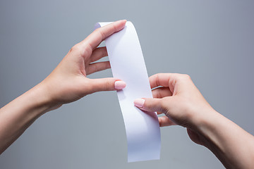 Image showing The female hands with  empty transaction paper or paper check