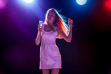 Image showing The beautiful girl dancing at the party drinking champagne