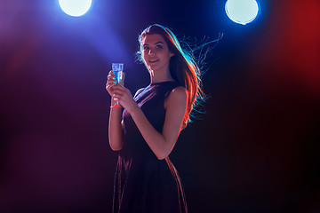 Image showing The beautiful girl dancing at the party drinking champagne