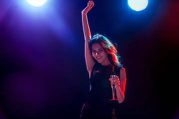 Image showing The beautiful girl dancing at the party drinking champagne