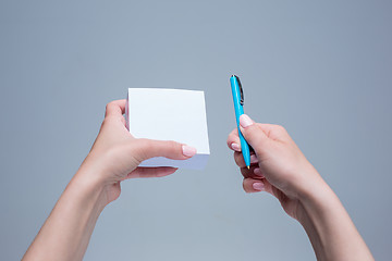 Image showing The notepad and pen in female hands