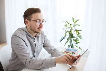 Image showing happy creative male office worker with tablet pc