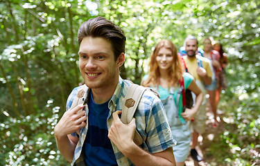 Image showing group of smiling friends with backpacks hiking