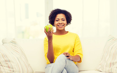 Image showing happy african american woman with green apple