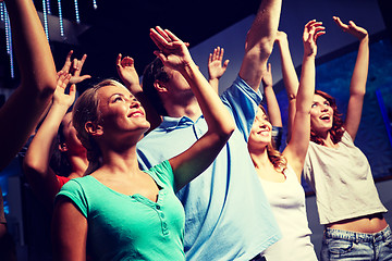 Image showing smiling friends at concert in club