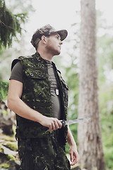 Image showing young soldier or hunter with knife in forest