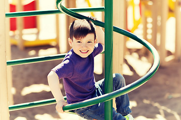 Image showing happy little boy climbing on children playground