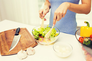 Image showing close up of woman cooking vegetable salad at home