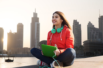 Image showing happy young woman with tablet pc and headphones