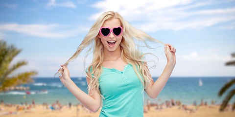 Image showing happy young blonde woman or teenager in sunglasses