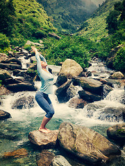 Image showing Sorty fit woman doing yoga asana Utkatasana outdoors