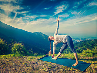 Image showing Woman doing Ashtanga Vinyasa yoga asana Utthita trikonasana