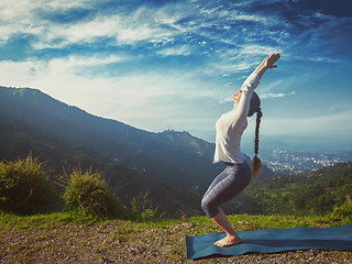 Image showing Woman doing yoga asana Utkatasana outdoors