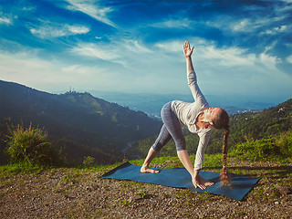 Image showing Woman doing Ashtanga Vinyasa yoga asana Parivrtta trikonasana