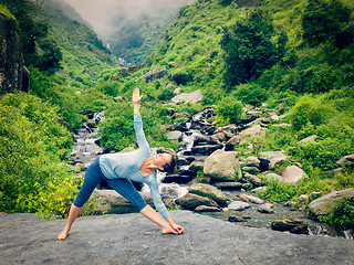 Image showing Woman doing Ashtanga Vinyasa yoga asana Utthita trikonasana