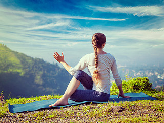 Image showing Woman practices yoga asana Marichyasana 