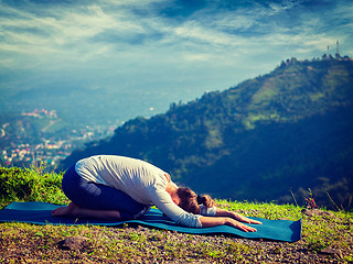 Image showing Sporty fit woman practices yoga asana Balasana