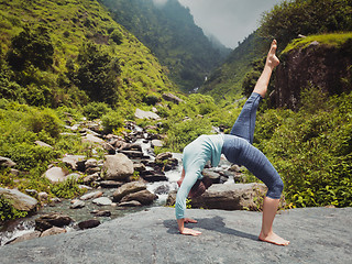 Image showing Woman doing yoga asana at waterfall