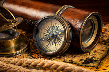 Image showing Old vintage compass and navigation instruments on ancient map