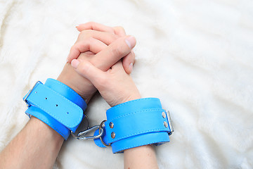 Image showing Male and female hands in handcuffs. sexy couple in bed. sex Toys