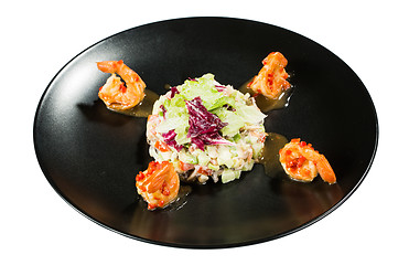 Image showing perfect dish with shrimps on a black plate. seafood. Isolated  white background