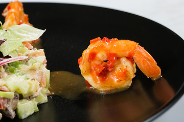 Image showing perfect dish with shrimps on a black plate. seafood