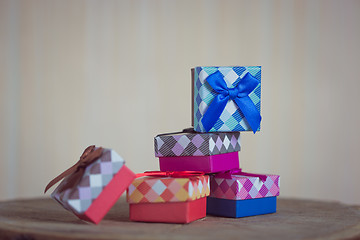 Image showing Gift box with blue bow on wood background