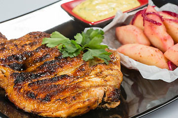 Image showing plate of grilled meat with fries