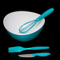 Image showing Green silicone pastry brush and soup plate isolated on black