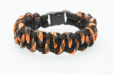 Image showing black and orange braided bracelet on white background