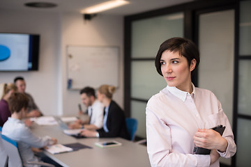 Image showing hispanic businesswoman with tablet at meeting room