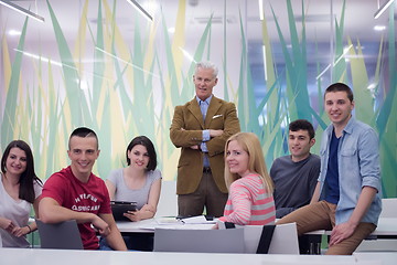 Image showing portrait of  teacher with students group in background