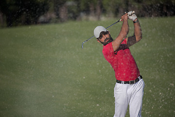 Image showing golfer hitting a sand bunker shot