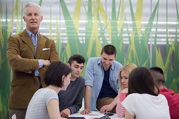 Image showing portrait of  teacher with students group in background