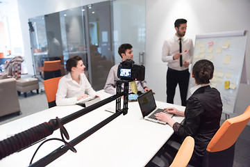 Image showing business people group brainstorming and taking notes to flip boa