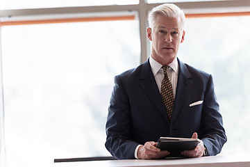 Image showing senior business man working on tablet computer