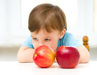 Image showing Portrait of a sad little boy with apples